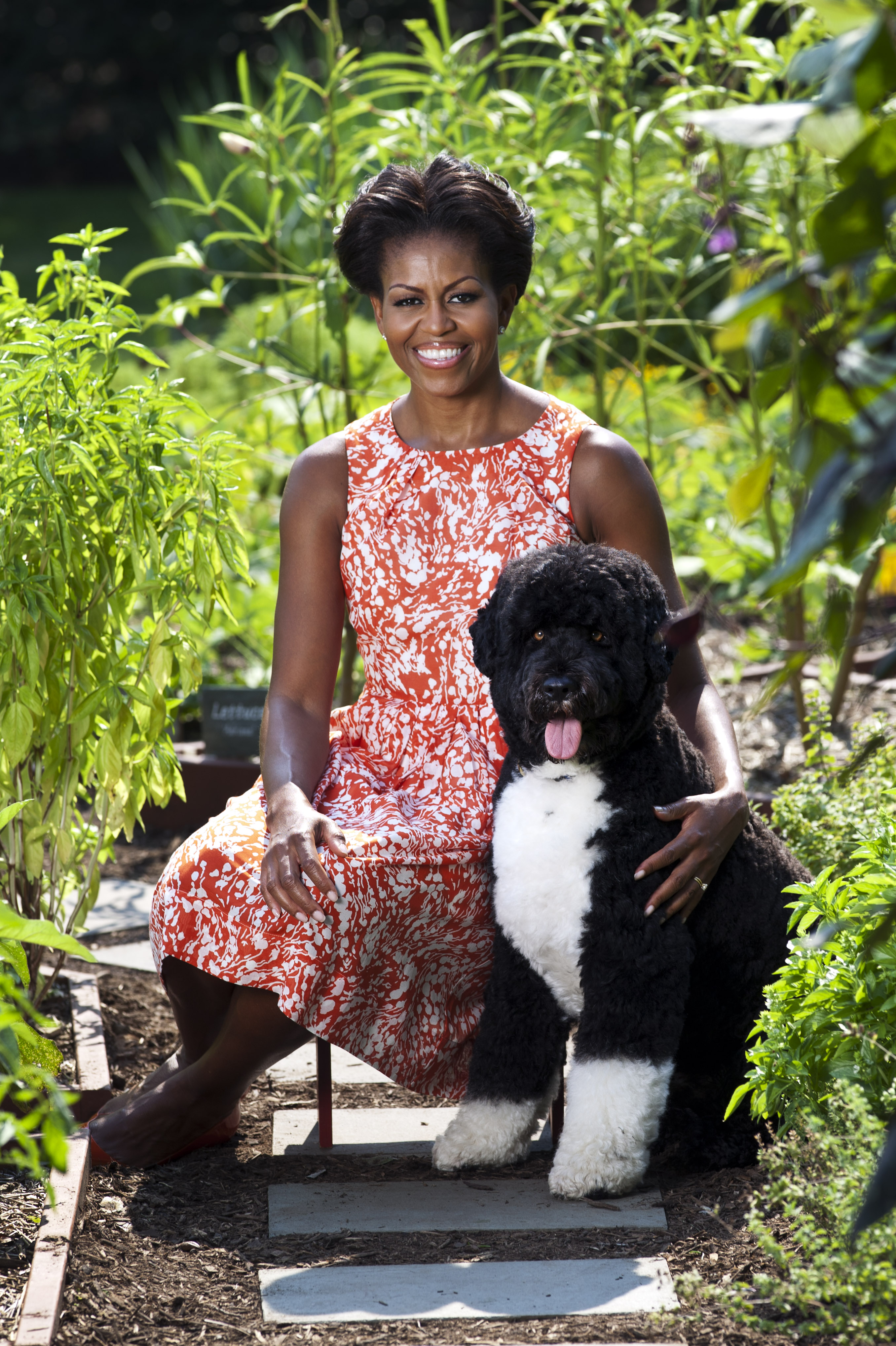 First Lady Michelle Obama poses for a portrait with the family dog, Bo.